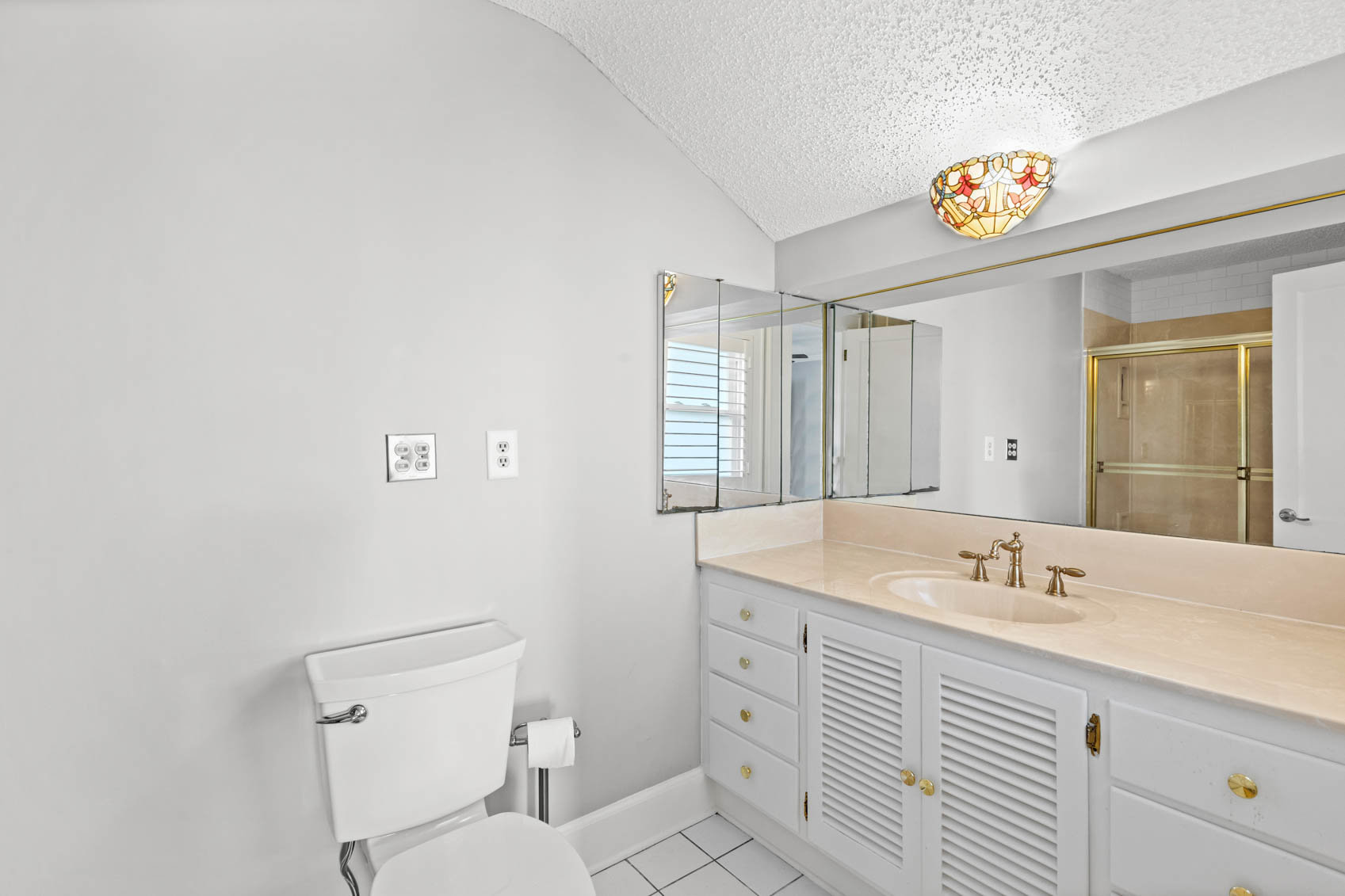 bathroom with white sink cabinet and toilet